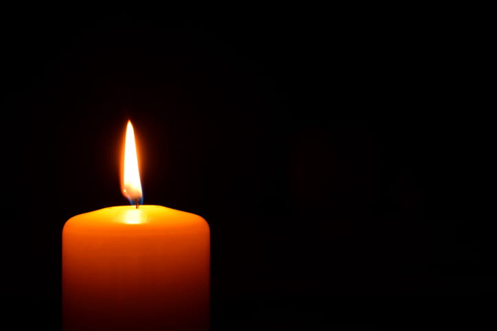 A candle lit in memorial for a wrongful death.