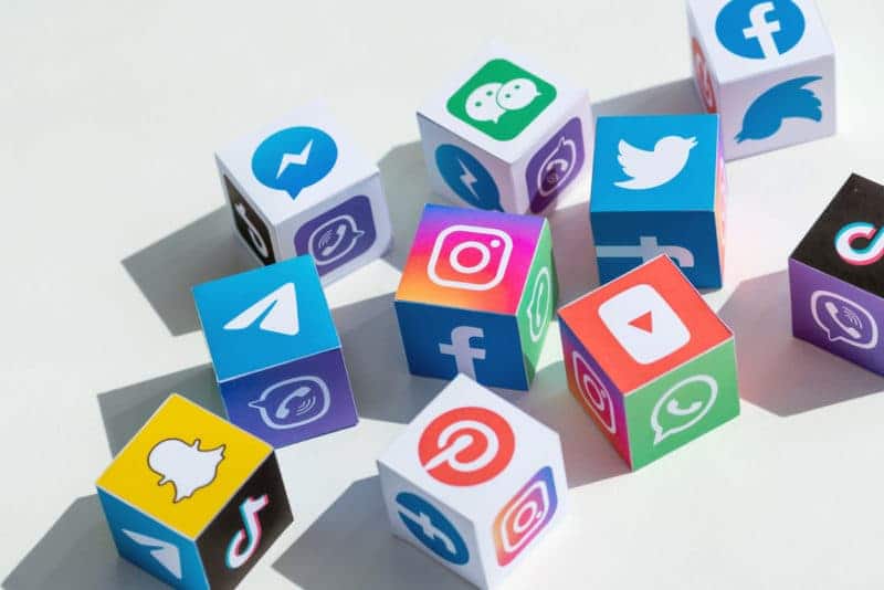 A photo of different social media logos on blocks like dice.