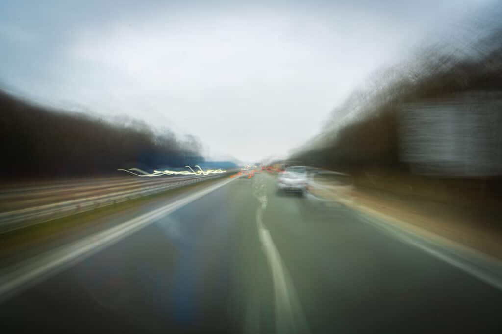 drunk driver view of a blurry road from a car