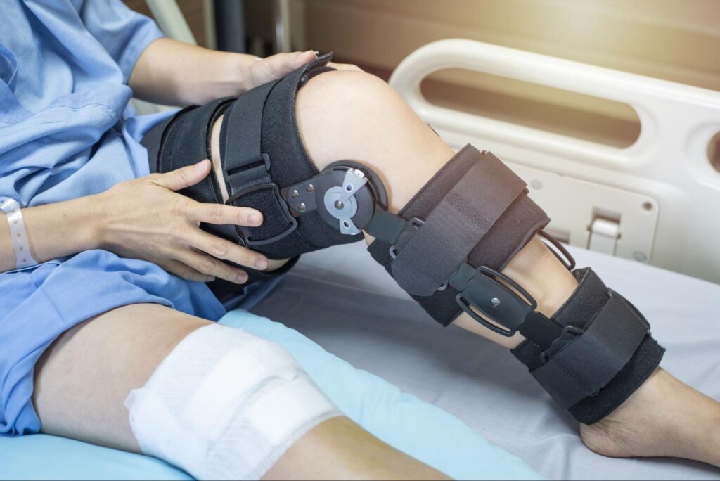 women with bandage compression knee brace support on her knee injury