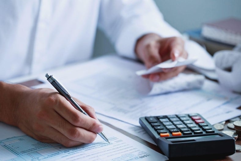 man doing taxes at a desk