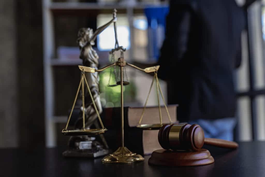 Wrongful Death Attorney's Desk With Scales of Justice, a gavel and law books
