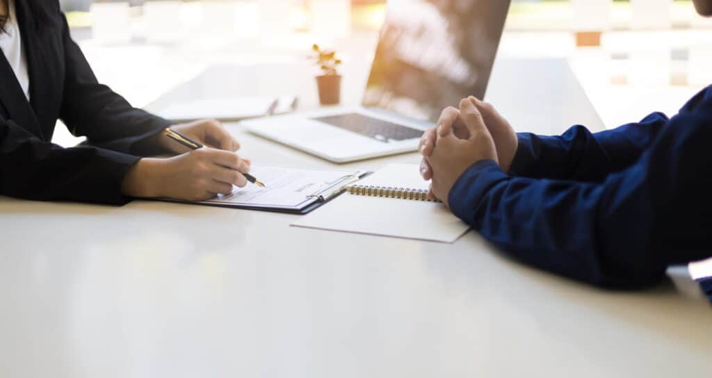 A wrongful death attorney reviewing paperwork with their client.