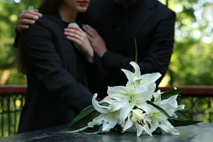 Two people mourning over the loss of their loved one after a wrongful death.
