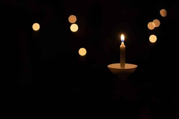 A candle lit in memorial of a wrongful death.